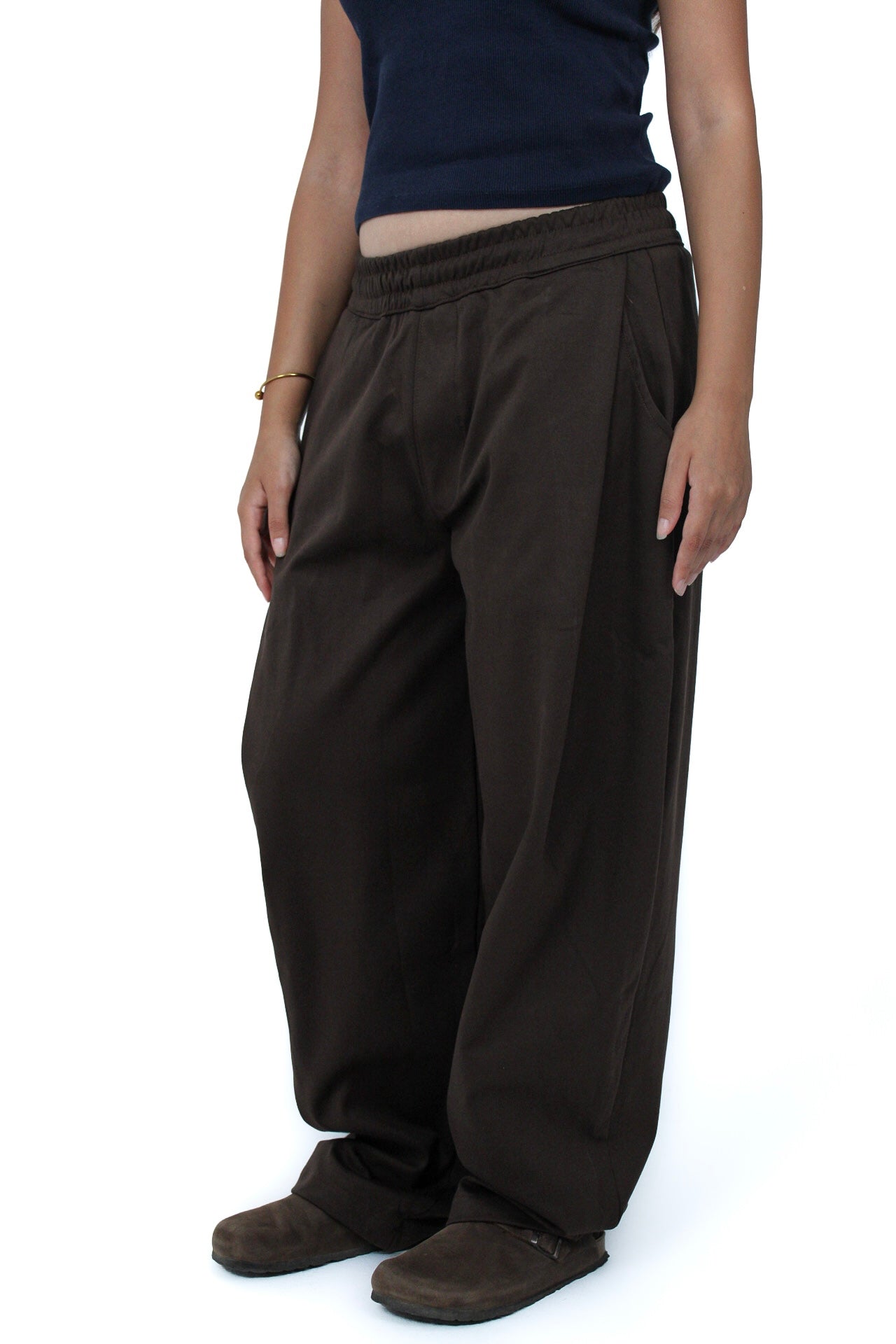 Pleated Balloon-Fit Pants in Brown, three-quarter view on model