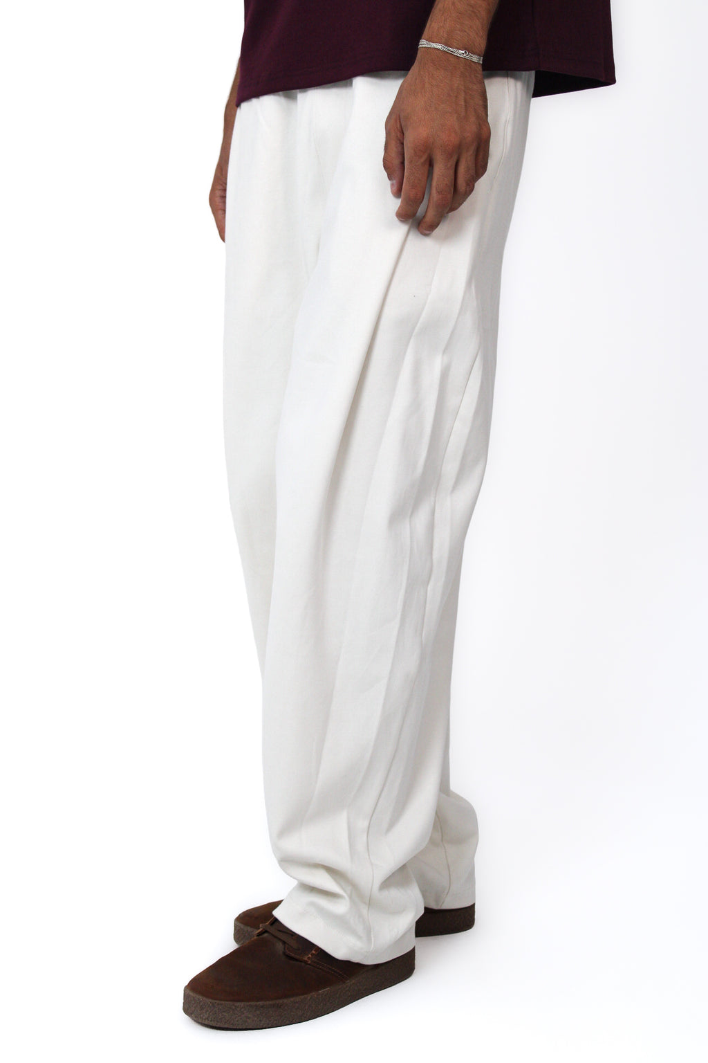 Pleated Balloon-Fit Pants in Off White, three-quarter view